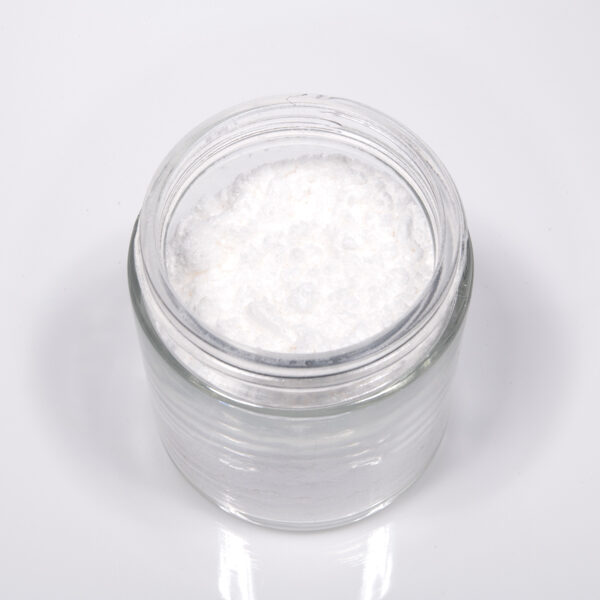 Top view of a small glass jar filled with white CBG isolate powder, used for its therapeutic properties, on a clean white background.